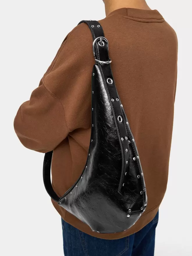 Asymmetric shoulder bag with studs