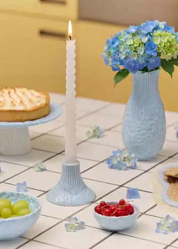 Blue candleholder with embossed hydrangeas