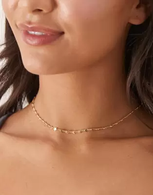 ASOS DESIGN necklace with dainty moon and star detail in gold tone