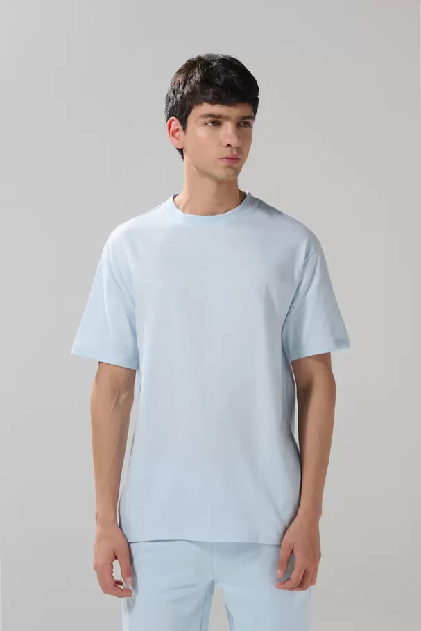 Camiseta unicolor manga corta con hombro rodado en algodón