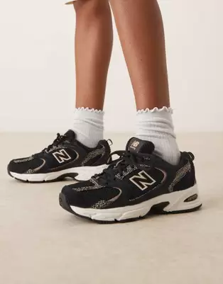 New Balance 530 trainers in black and leopard print
