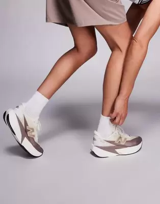 New Balance Fuelcell Rebel v5 womens running trainers in brown and beige