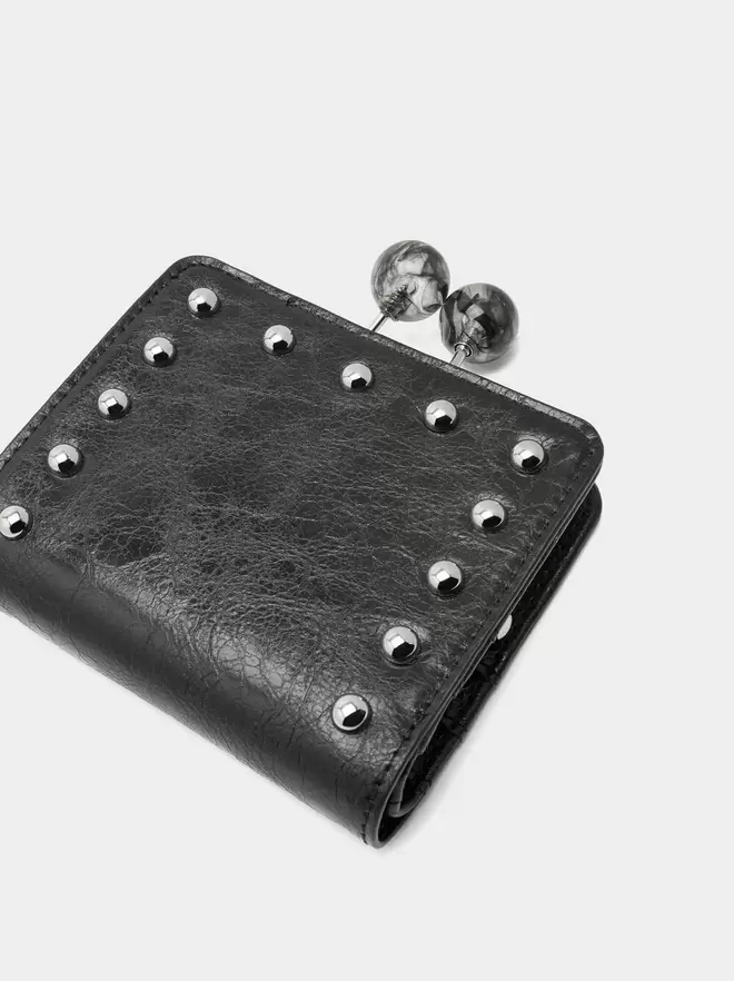 Wallet with studs and kiss-lock closure
