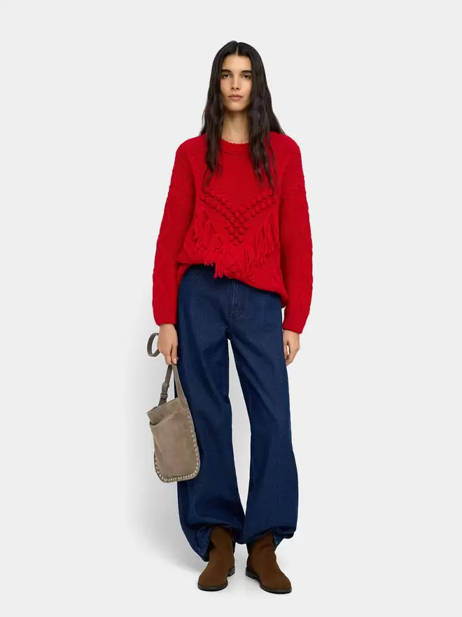 Knit sweater with fringes and reliefs