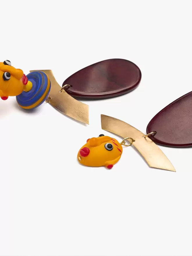 Asymmetric earrings with masks