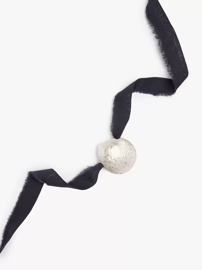 Necklace in fabric with shell