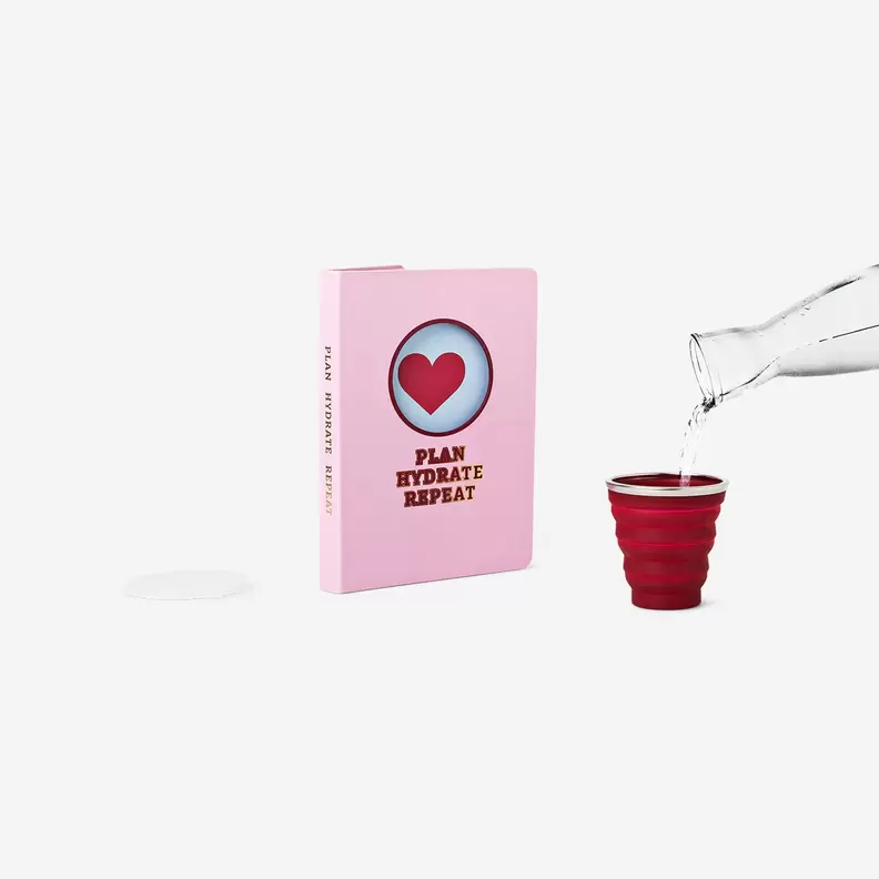 Pink notebook with cup
