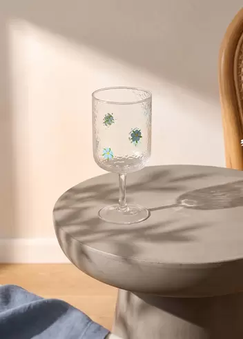 Wine glass with blue embossed flo...