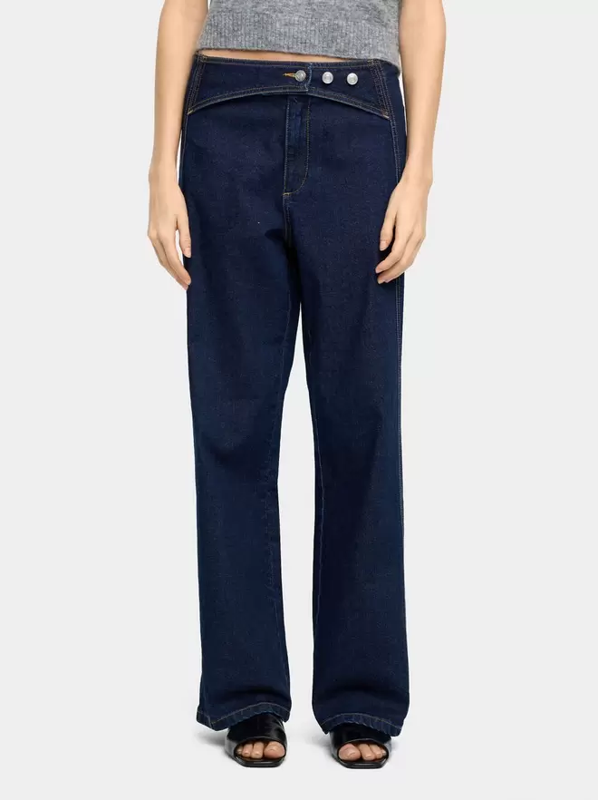 Denim trousers with overlap closure