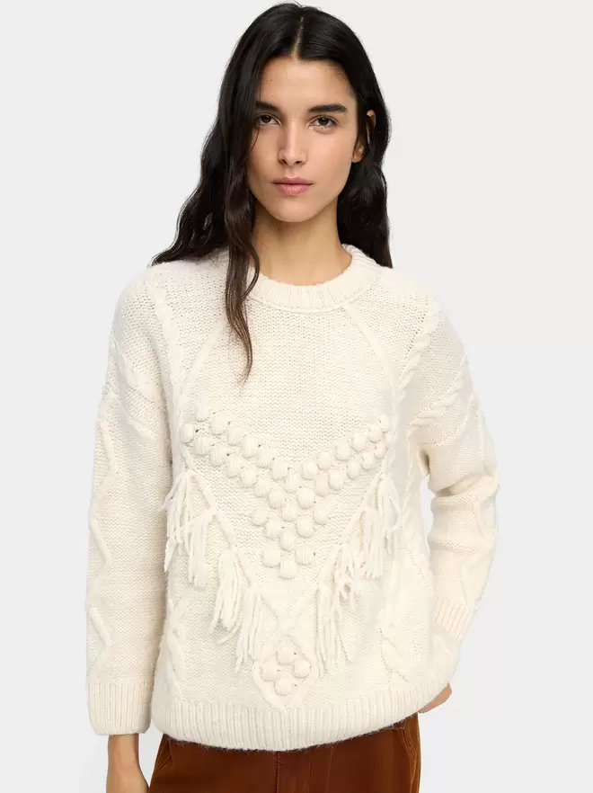 Knit sweater with fringes and reliefs