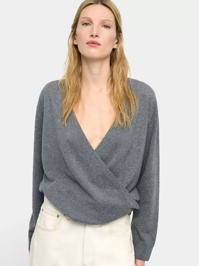 Knit sweater with crossover