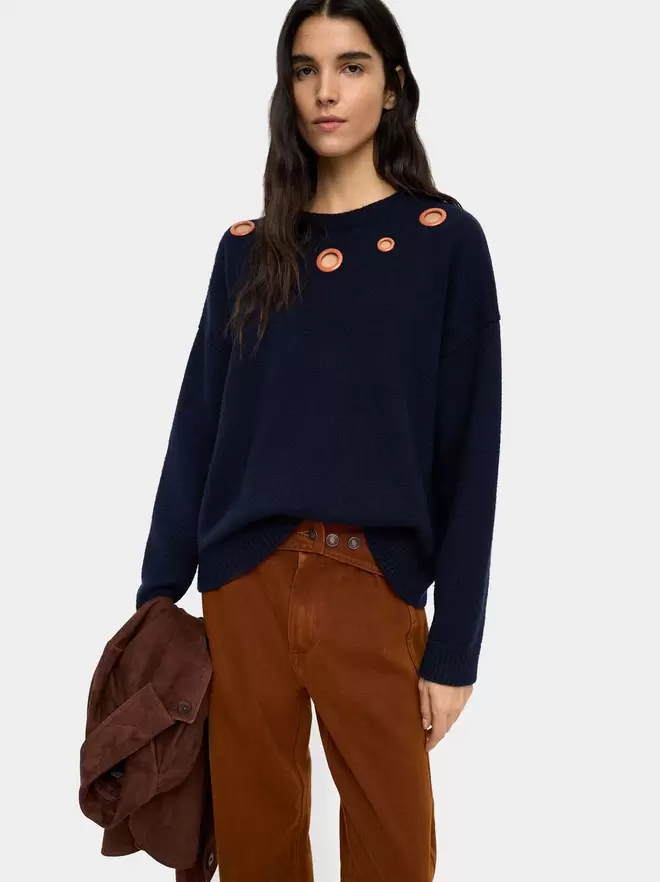 Knit sweater with eyelets