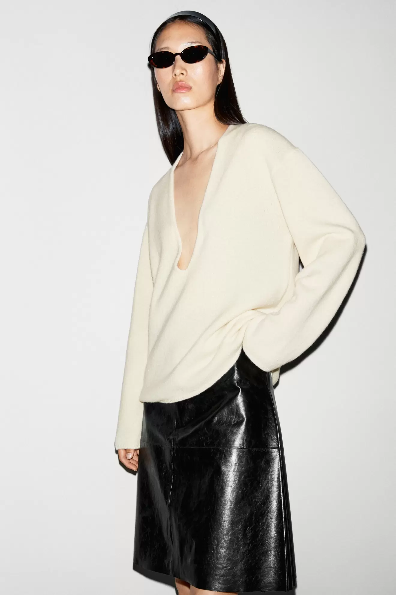 Long-line knit sweater with neckline detail