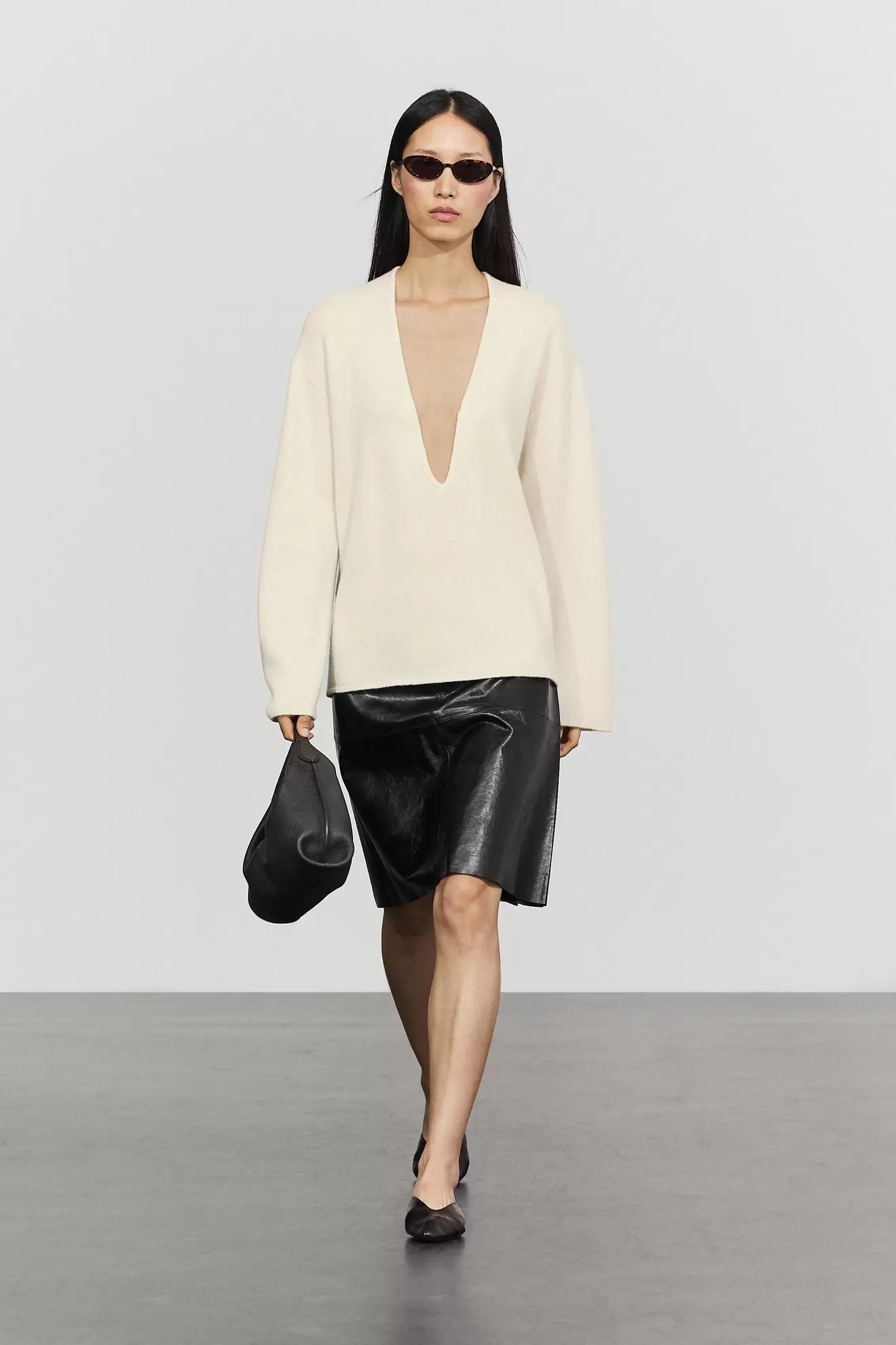 Long-line knit sweater with neckline detail